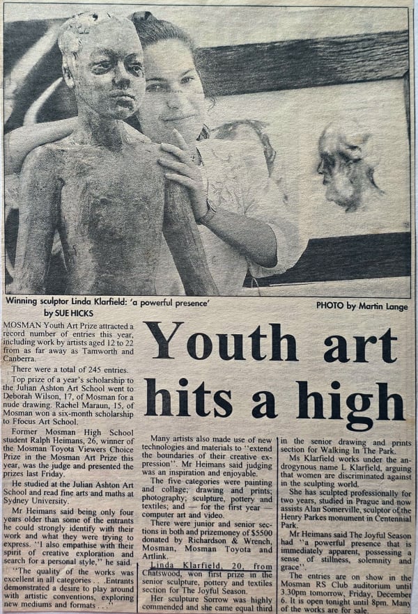A newspaper article titled "Youth art hits a high" by Sue Hicks, featuring a black-and-white photograph of Linda Klarfeld, aged 20, standing next to her sculpture. The image shows Klarfeld adjusting a life-size sculpture of a young figure with a contempla