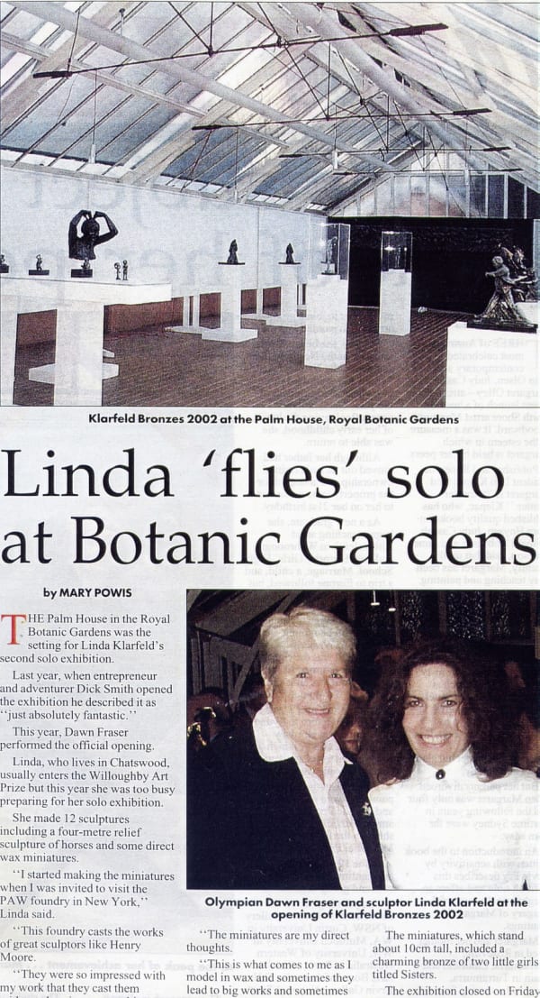 An article titled "Linda 'flies' solo at Botanic Gardens" by Mary Powis, featuring sculptor Linda Klarfeld and Olympian Dawn Fraser at the opening of Klarfeld's 2002 solo exhibition at the Palm House in the Royal Botanic Gardens. The top half of the image