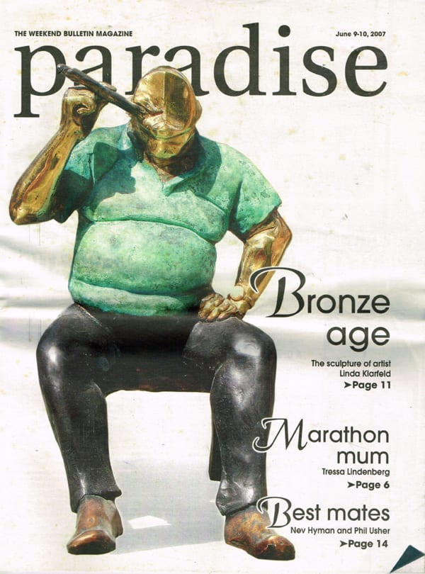 The cover of the "Weekend Bulletin Magazine" from June 9-10, 2007, featuring a sculpture by Linda Klarfeld. The artwork depicts a bronze figure of a seated man with a large, exaggerated belly, wearing a green shirt and black pants. The figure is humorousl