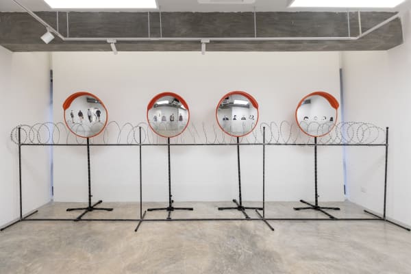 Zulkefli Jais Watchtower, 2025 Convex mirrors, galvanized iron pipes, fencing, barbed wire, suitable GI pipes and fittings, thermal blanket and collage 212 x 630 x 115 cm