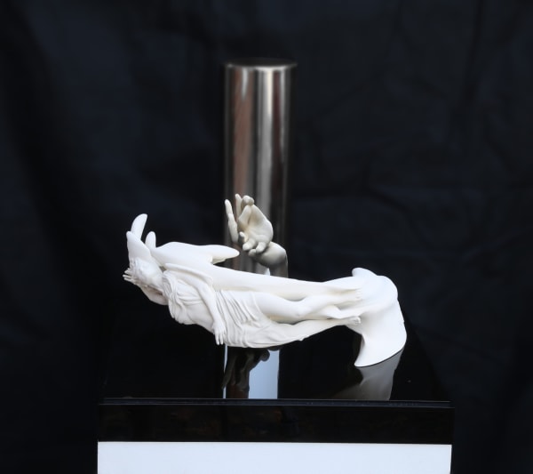 Visual illusion art of a couple which appears transforms into a hand when looked at in a cylindrical mirror in the centre