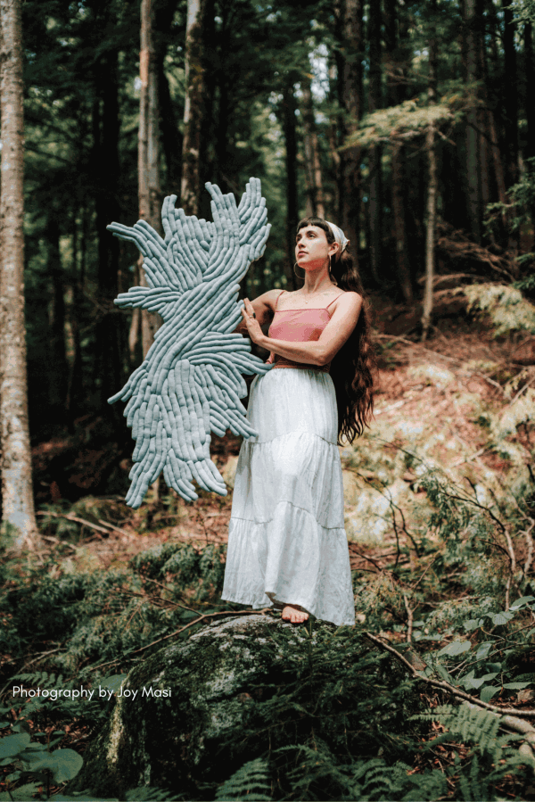 Sienna Martz and her sculpture 'MagMoon' Upcycled fabric, upcycled polyester filling, thread, non-solvent adhesive, mounted on wood. Photography by Joy Masi.