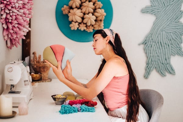 Sienna Martz in her studio, surrounded by works-in-progress shaped from salvaged textiles and plant fibers.Photo: Joy Masi, 2023