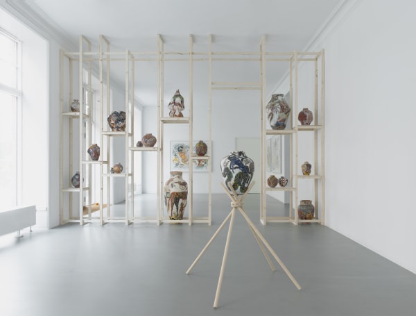 Gallery view of Karim Boumjimar’s Mouths, Vessels, Portals (2025), featuring framed works on paper alongside earthenware sculptures.