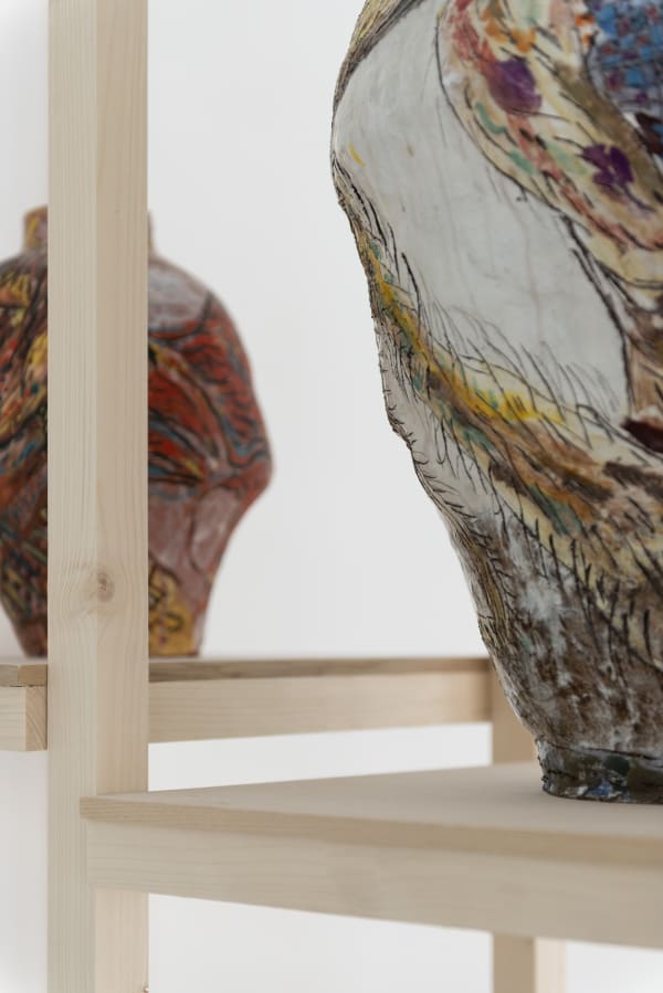 Detail of an installation from Karim Boumjimar’s Mouths, Vessels, Portals (2025), combining chalk drawings on canvas with ceramic forms.