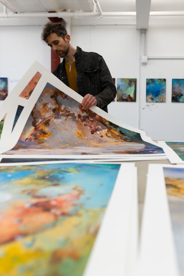 Chris Rivers inspecting his The Zodiac Universe print series