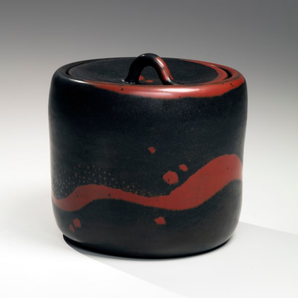 Columnar black-glazed mizusashi (water jar) with red undulating bands and spotted patterning, and recessed matching ceramic lid with looped handle 2016 Glazed stoneware 6 x 6 1/8 in. Inv# 9723