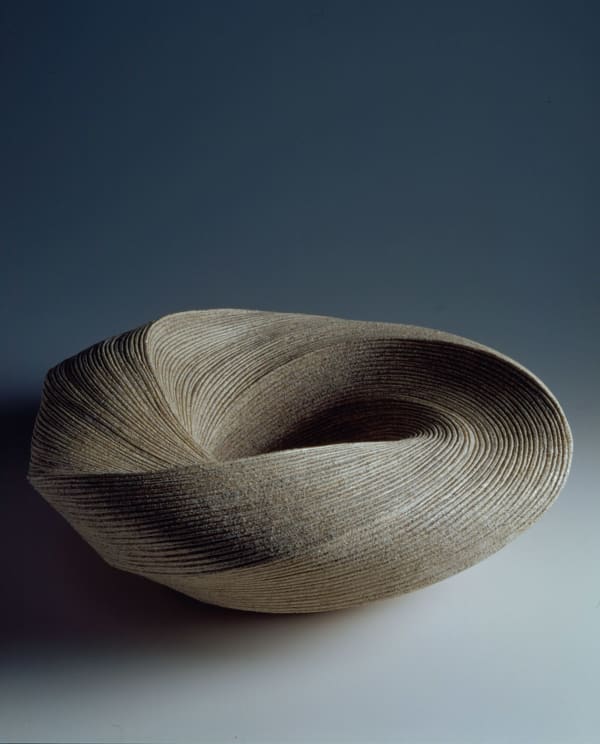 Large, ﬂattened round vessel with diagonally incised cascading folds 2007 Stoneware with sand glaze 7 1/4 x 22 x 21 3/4 inches Inv# 5415