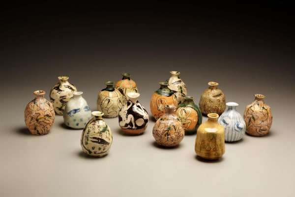 Suzuki Goro (b. 1941) Set of 15 sake flasks in oribe glaze with whimsical designs of crows, nude women and short poems, ca. 1995 Stoneware; 3 1/8 x 2 3/4 x 2 3/4 inches Inv# 6139