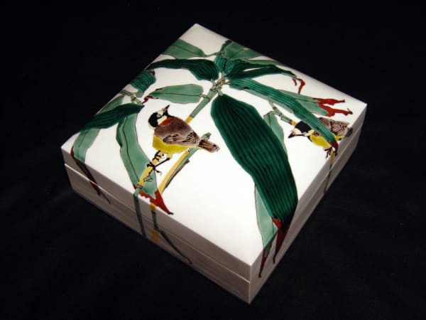 Covered square box with varied tits perched on bamboo grasses, 2010 Porcelain with polychrome enamel glazes 4 5/8 x 10 1/4 inches Inv# 6683 SOLD