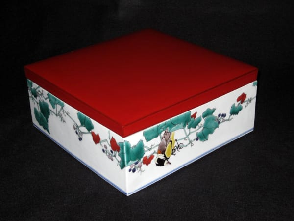 Low square box decorated with varied tits perched on wild grape vines, 2010 Porcelain with polychrome enamel glazes with red lacquer cover 5 x 1 1 x 10 7/8 inches Inv# 6679 SOLD