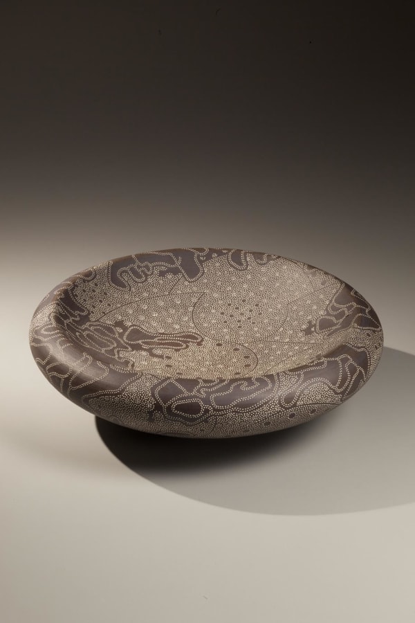Kitamura Junko (b. 1956) Low, round, double-walled concave dish, decorated with punched-patterning accentuated and white slip inlays, 2009 Stoneware glazed with black slip and white slip inlay (mishima style) 4 x 9 1/4 inches Inv# 6817; SOLD