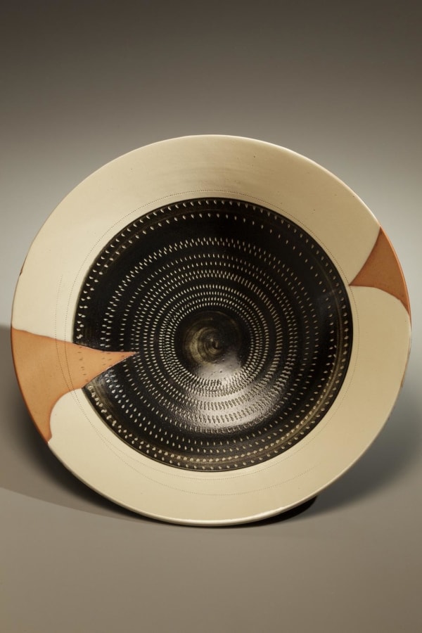 KONDO YUTAKA (1932-1983) Textured white & black glazed stoneware round plate w/ rouletted pattern & white slip inlay Textured black glazed stoneware, white slip inlay impressed areas, ca. 1968 3 5/8 x 15 3/4 inches Inv# 7012 SOLD