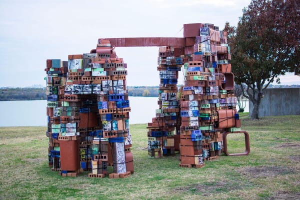 “Brickolage at TCC Northwest Campus,” a new sculpture by NW art associate professor Fred Spaulding, frames the lake as it sits on the south end of the Fine Arts Building. Photo by Jason Floyd/The Collegian