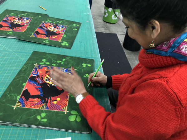 Artist Chila Kumari Singh Burman signing her specially commissioned limited edition print for Art For Your World.