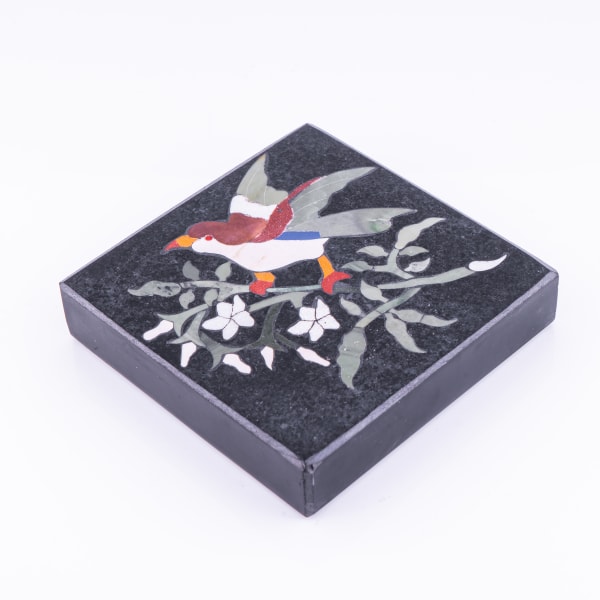 A paperweight with a bird on branch