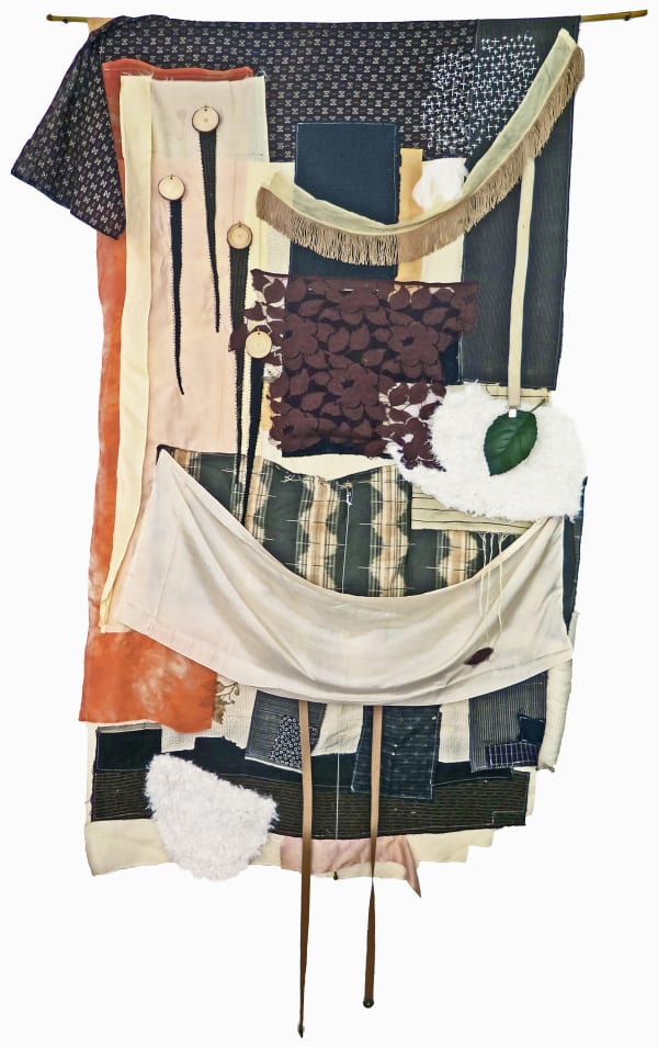 Some Birds Fly North (2019) Boro fabric, vintage silk, other fabric, faux fur, machine and hand embroidery, artificial leaf, suspender strap, stuffing in places, wood discs, hanging from a dowel. 85 x 42 inches