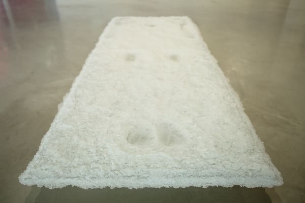 Kowtow (2015), an ethereal sculpture of textured glass, likens the emotional quality of a deeply respectful bow to “the tender...
