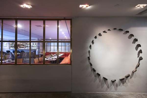 Installation view of LEE LEE CHAN’s Absorber #2, 2017, found asphalt, nails, metallic paint, glitter, dimensions variable. Courtesy the artist.