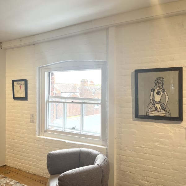 From left: framed works by John Kiki