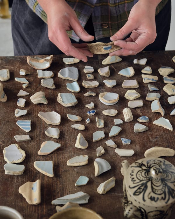 Shards from mudlarking are dotted and decorated all around the studio