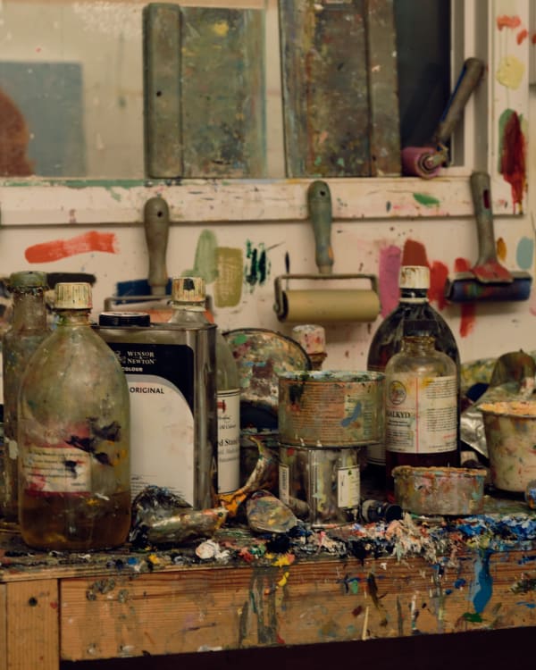 Tubs of oil and tubes of paint awaiting use.