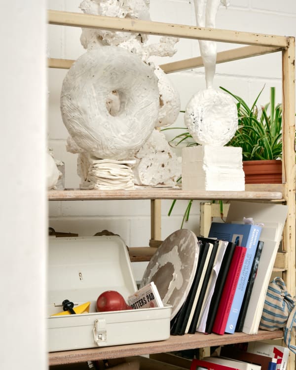 A toolbox in the studio includes a slip trail that she uses to achieve her signature spiked detailing