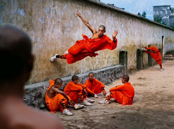 Steve McCurry, Monk Running on Wall, 2004
