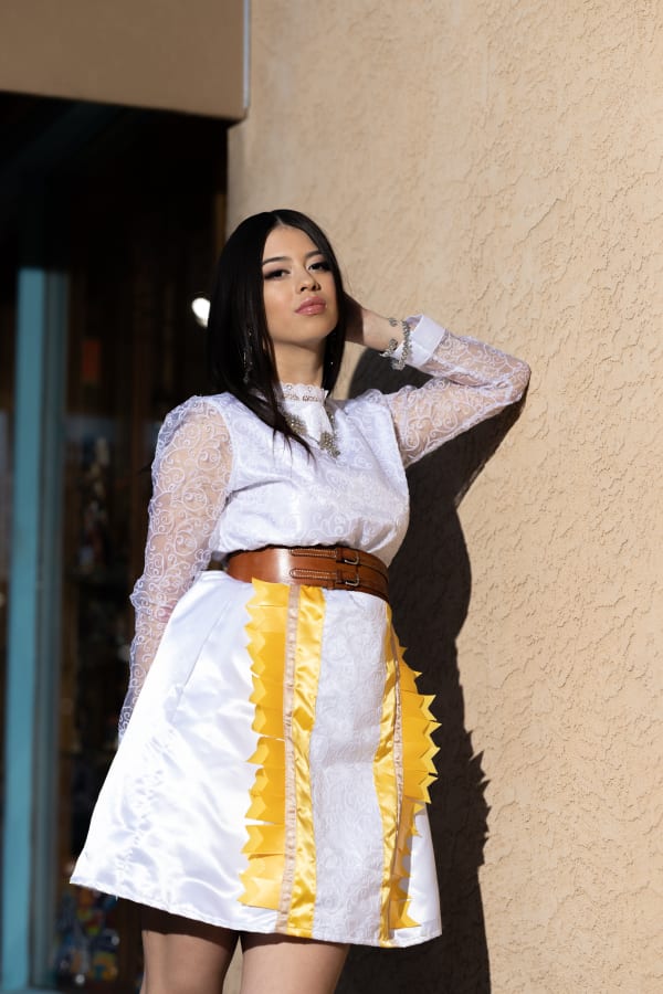 Woman with black hair in white dress