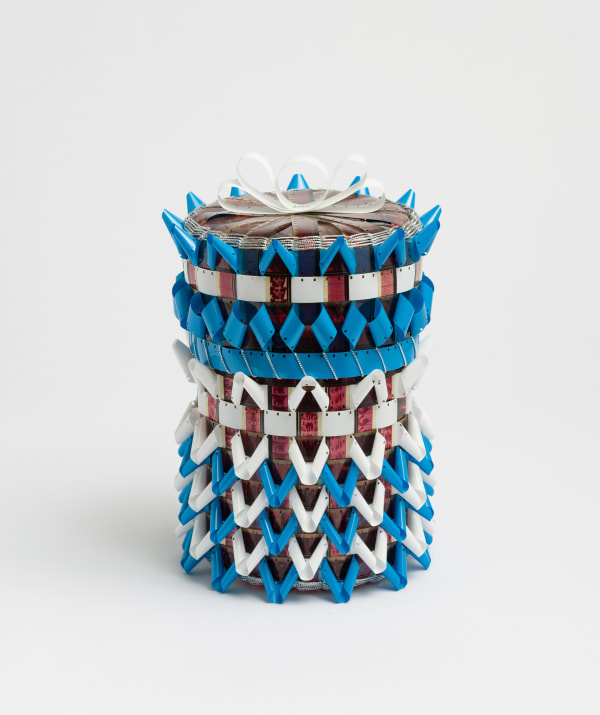 Gail Tremblay Dreaming in the Cherokee Syllabary, 2017 16mm film (North American Indians, Part II: How the West Was Won, and Honor Lost, 1970), blue and white 16mm film leader, silver metallic braid 10 1/4 x 7 x 7 in
