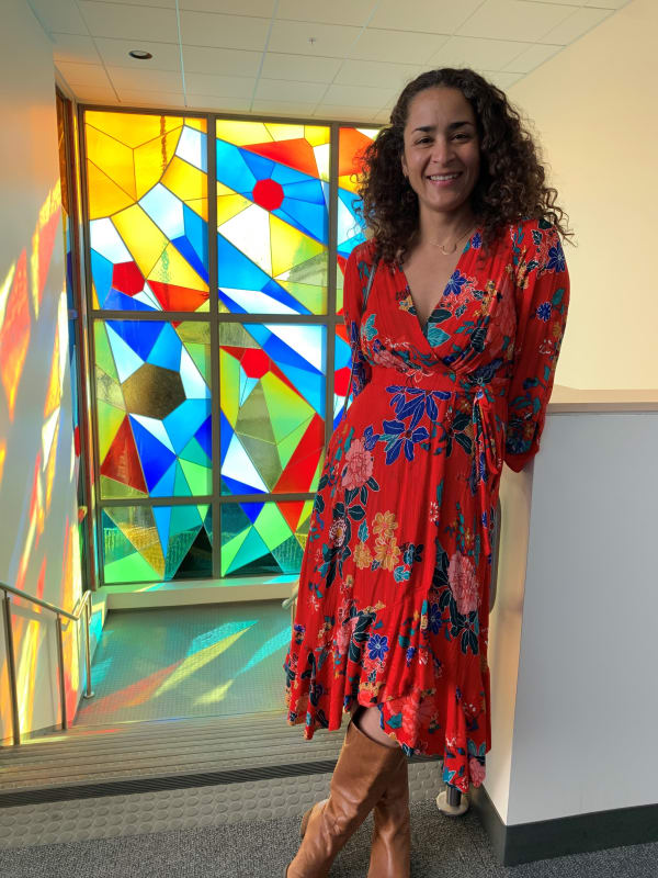 Artist Adia Millett in front of the artwork