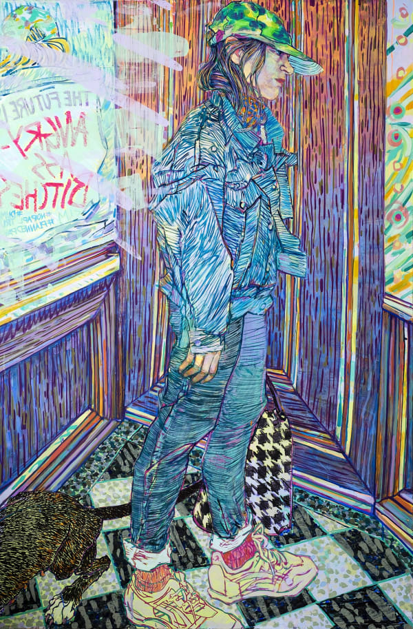 Full length three-quarter view of a young woman in a baseball cap, denim jacket and jeans, standing in the corner of a room with windows looking outdoors, with signs taped to the windows