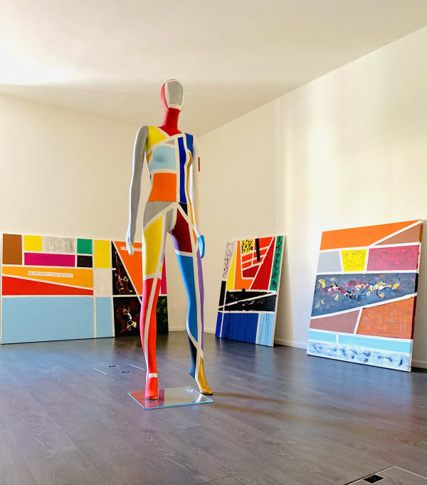A sculpture "Streets of Woman", 2019 Gigi Rigamonti front of series of work "Streets of Life", 2019 by Gigi Rigamonti