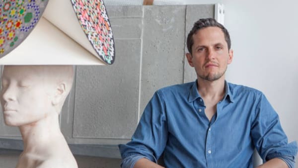 Charles Avery beside a bonnet from his ‘Islanders’ project