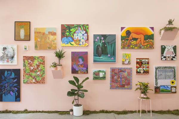 installation view of Lush 2022, gallery with peach walls and floral / plant themed artwork