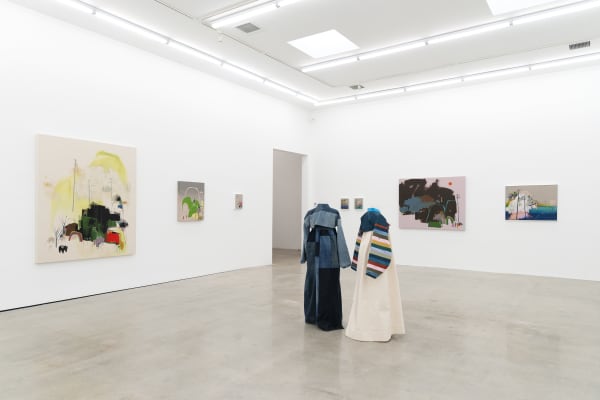 Seonna Hong installation view of solo exhibition Late Bloomer, two mannequins adorned with hanbok in center, large paintings in background on walls