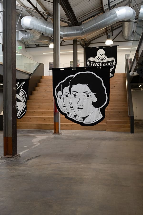 black and white embroided banners hung in the atrium of Minnesota Street Projects