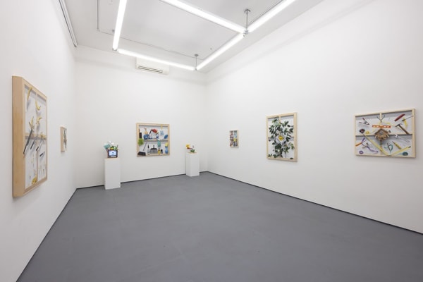 Paintings on wall with sculptures next to them at Stephen Morrison Dog show #4: House Broken exhibit