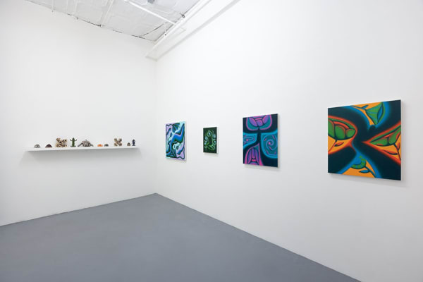 installation picture of Jocelyn Tsaih's "The Garden is Open" featuring paintings on the right wall and small statues on the left