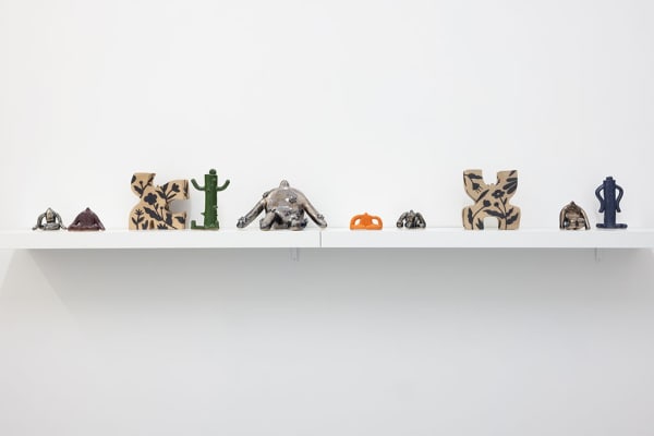 installation picture of Jocelyn Tsaih's "The Garden is Open" featuring a shelf of small colorful statues