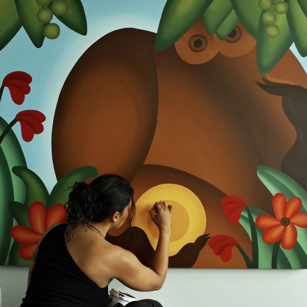 Artist Bianca Nemelc working on a painting in her studio.