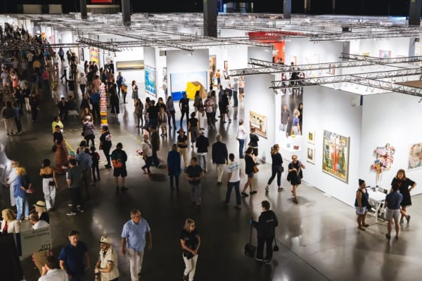 Aerial view of crowd and booth installation at Seattle Art Fair