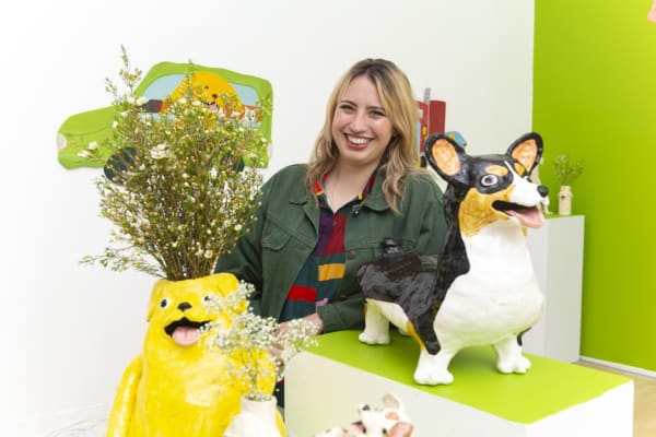 Portrait of artist Katie Kimmel with her ceramic dog vases