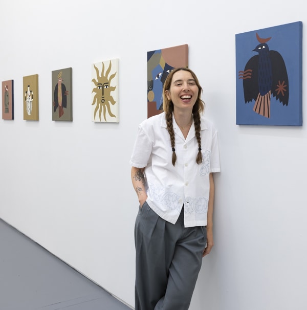 portrait of artist Madi with her work