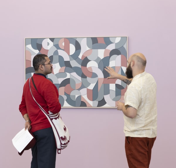 two people standing in front of a Scott Albrecht artwork