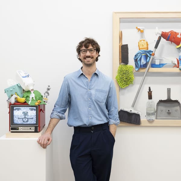 picture of the artist Stephen Morrison posing with his work