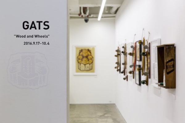 Installation view of GATS show, featuring large painting and dozens of painted vintage skateboards