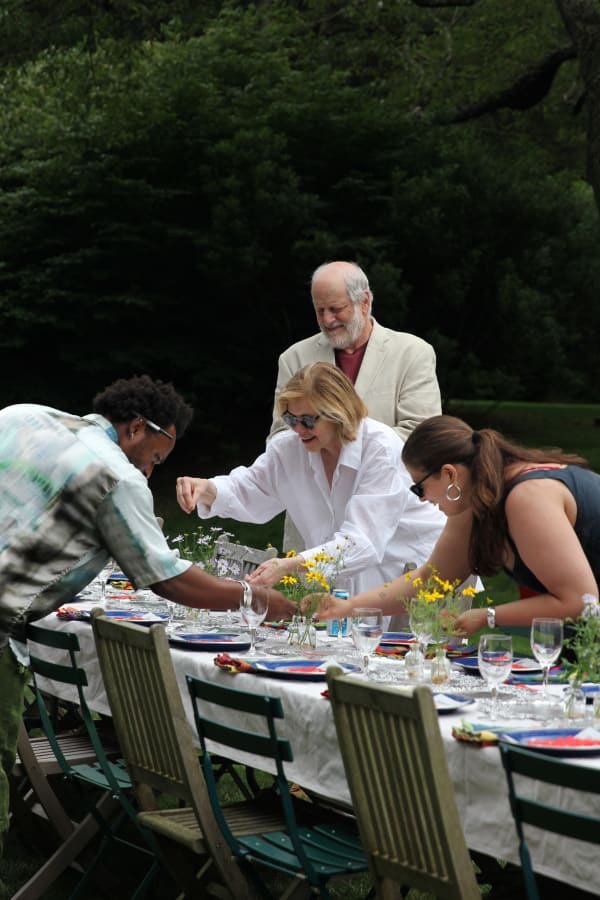 Karen Hesse Flatow, along with Emma Safir and her family, set the table with hand-folded place cards and flower arrangements from the Amagansett Gallery's garden