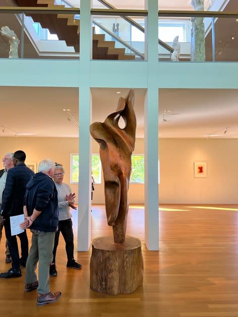 Visitors with 'Aurora', carved from cedar wood