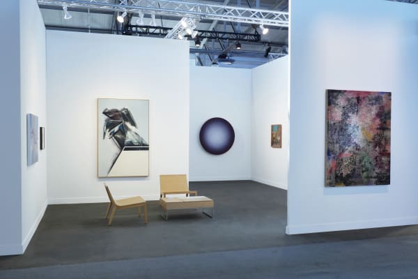 installation of FOG booth with artworks hung up against white walls in an open space.
